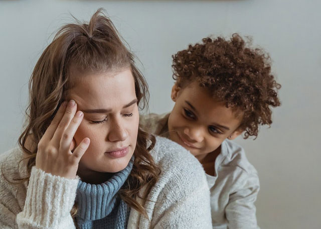 Aloha at Home - Mother with emotional distress, while child looks at mom. All Parents need help sometimes